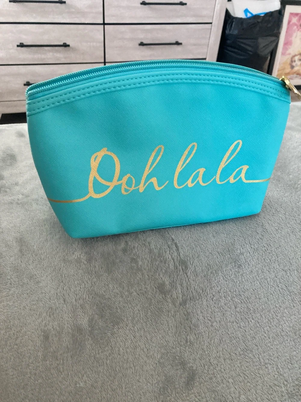 Turquoise colored faux leather cosmetic bag